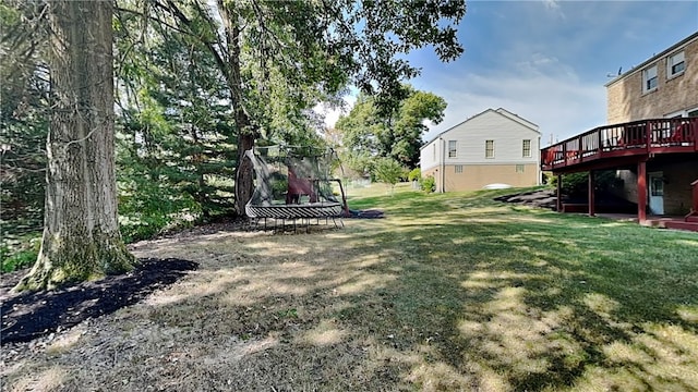 view of yard with a deck and a trampoline