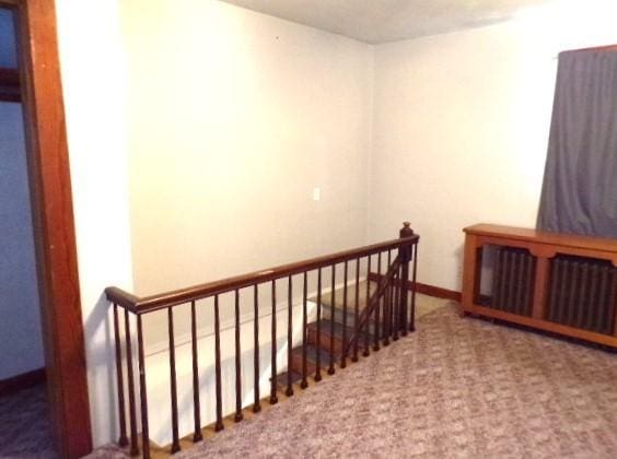 stairway with carpet flooring and baseboards