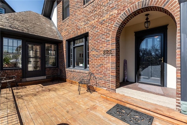 entrance to property featuring brick siding