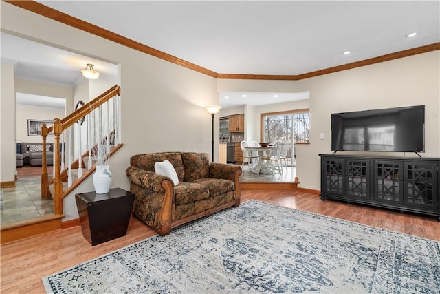 living area featuring wood finished floors, recessed lighting, crown molding, baseboards, and stairs