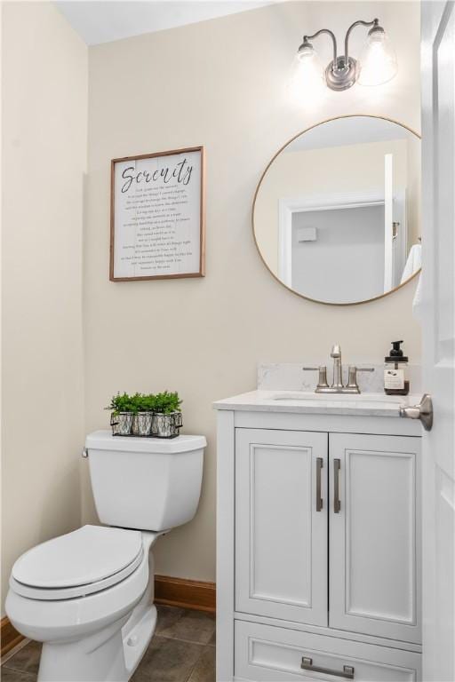 bathroom featuring vanity, tile patterned floors, toilet, and baseboards