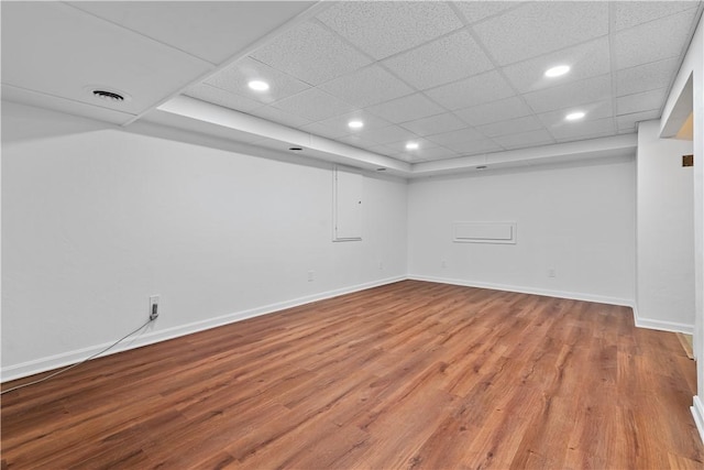 spare room with visible vents, recessed lighting, wood finished floors, and baseboards