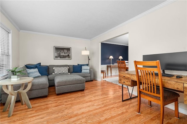 living area featuring baseboards, light wood-style floors, and ornamental molding