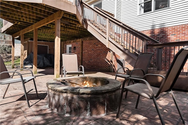 view of patio with stairway and an outdoor fire pit