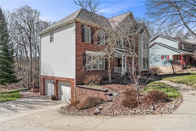 view of front facade with an attached garage, brick siding, and driveway