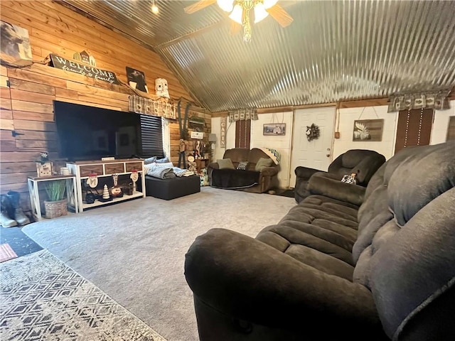 carpeted living area featuring lofted ceiling, wooden walls, and ceiling fan