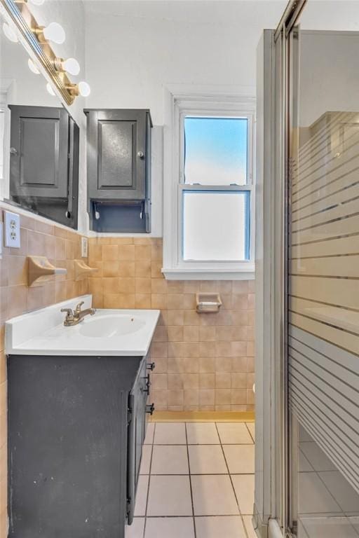 bathroom featuring vanity, tile patterned floors, and tile walls