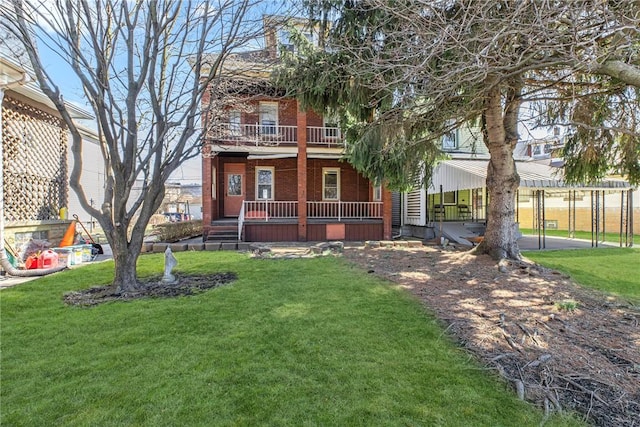 view of front of house with brick siding, covered porch, a balcony, and a front lawn