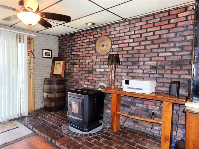 interior space featuring a ceiling fan and a wood stove