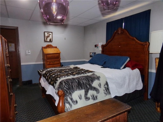 bedroom featuring a paneled ceiling and carpet floors