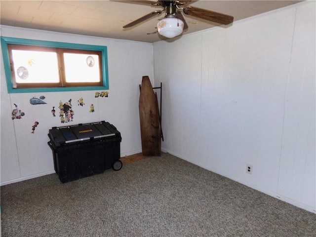 carpeted empty room featuring ceiling fan