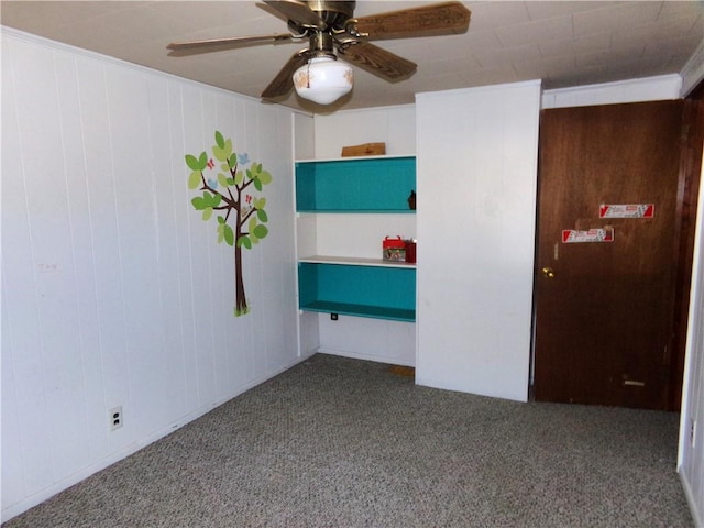 unfurnished room featuring carpet floors and a ceiling fan