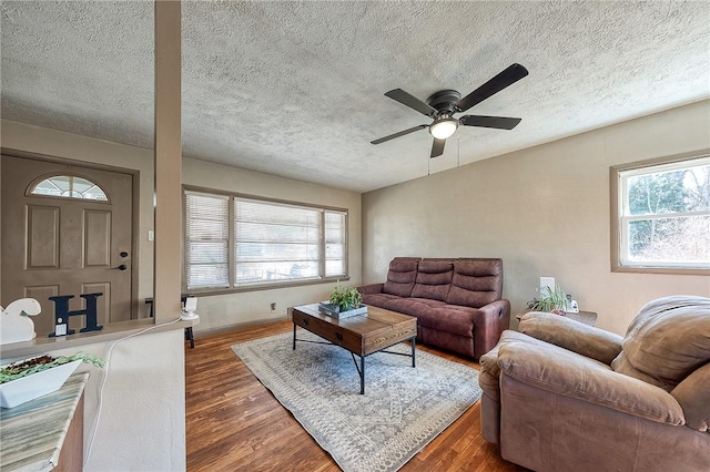 living area featuring a textured ceiling, ceiling fan, and wood finished floors