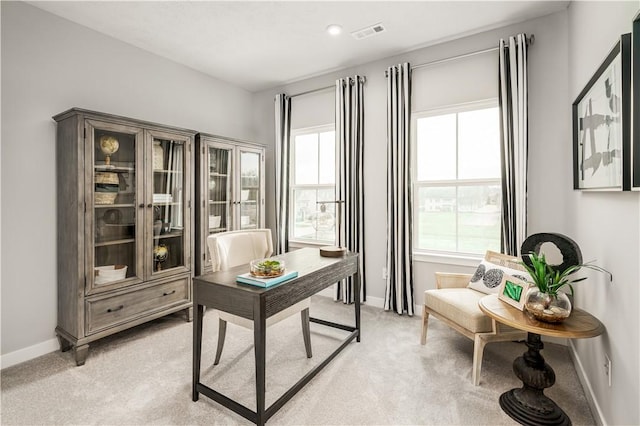 office space featuring visible vents, baseboards, and light colored carpet