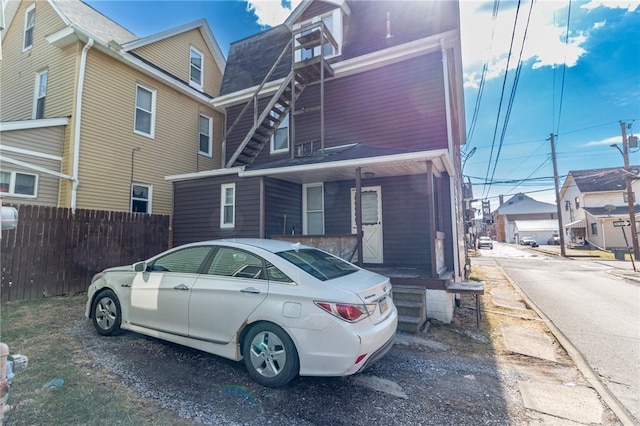 view of front of home featuring fence and a residential view