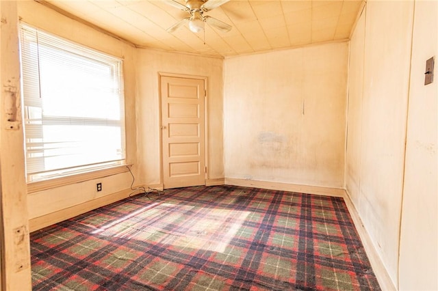 empty room with baseboards and a ceiling fan