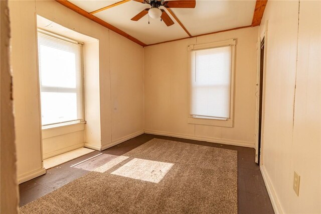 unfurnished room featuring baseboards, ceiling fan, and ornamental molding