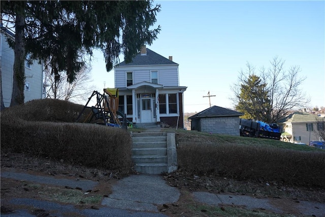 view of front facade featuring a chimney