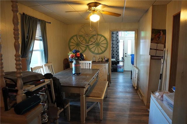 dining area with ceiling fan, radiator, and dark wood-style floors