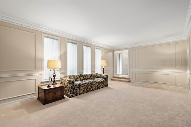 carpeted living area with a decorative wall and crown molding