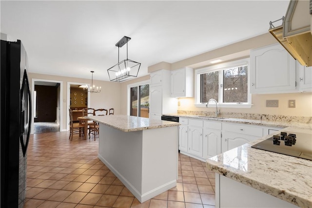 kitchen featuring light tile patterned flooring, white cabinets, black appliances, and a sink