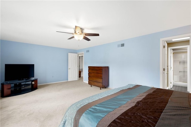 carpeted bedroom featuring visible vents, baseboards, and ceiling fan