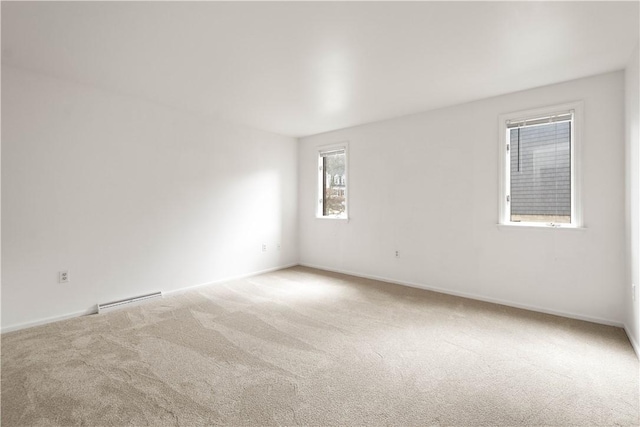 spare room with carpet flooring and baseboards