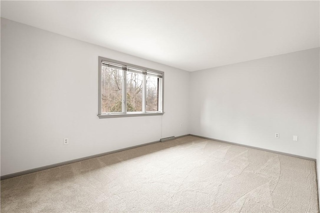 unfurnished room featuring visible vents, baseboards, and light carpet