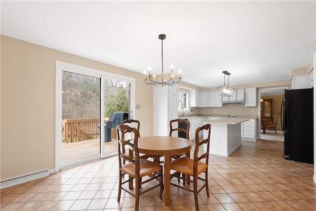 dining room featuring light tile patterned floors, baseboards, a baseboard heating unit, and an inviting chandelier