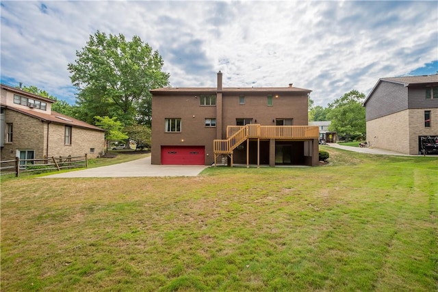 back of house featuring driveway, a wooden deck, a yard, stairs, and a garage