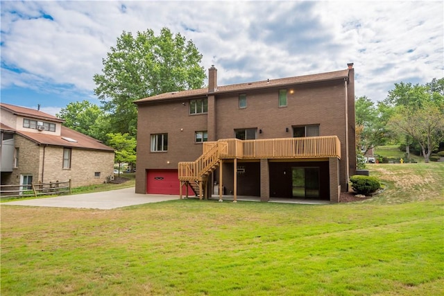 rear view of house featuring an attached garage, a chimney, stairs, concrete driveway, and a lawn