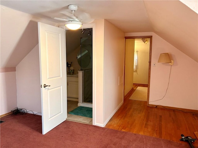 additional living space featuring baseboards, lofted ceiling, ceiling fan, and carpet flooring