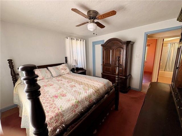 bedroom featuring a ceiling fan, baseboards, dark colored carpet, and a textured ceiling