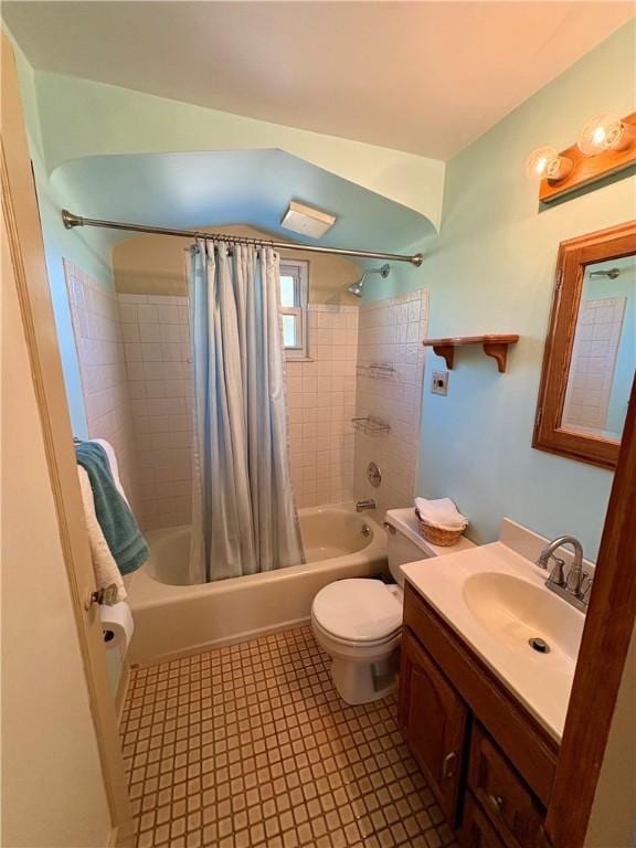 bathroom with shower / bathtub combination with curtain, toilet, and vanity