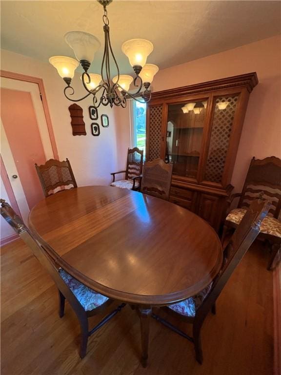 dining area featuring an inviting chandelier and wood finished floors