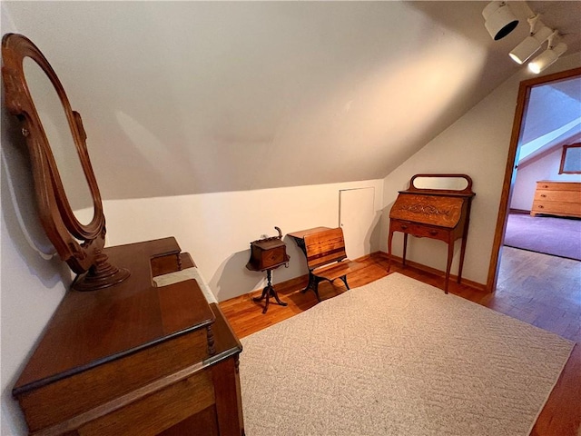 living area with lofted ceiling and wood finished floors