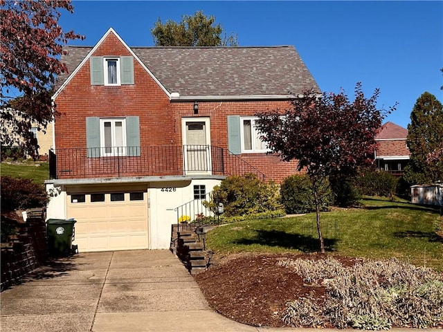 view of front facade featuring roof with shingles, concrete driveway, a front yard, a garage, and brick siding