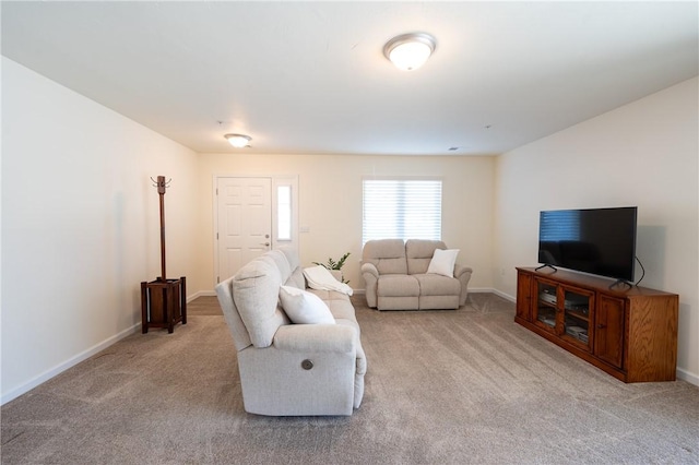 carpeted living room featuring baseboards