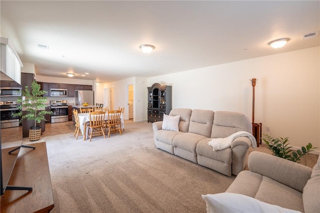 living room with visible vents and light carpet