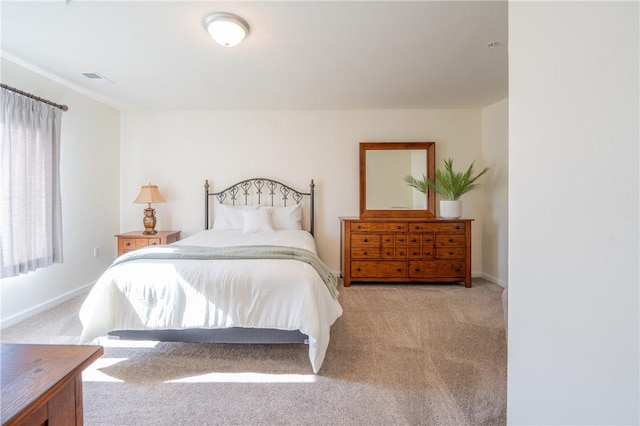 carpeted bedroom featuring visible vents and baseboards