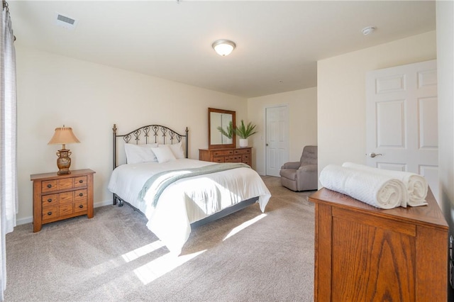 bedroom featuring light carpet and visible vents