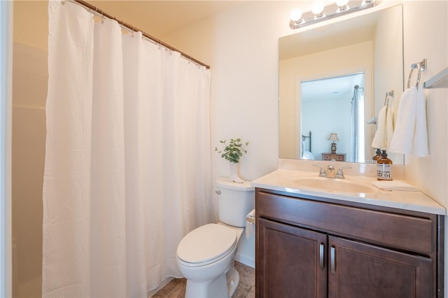 bathroom featuring toilet and vanity