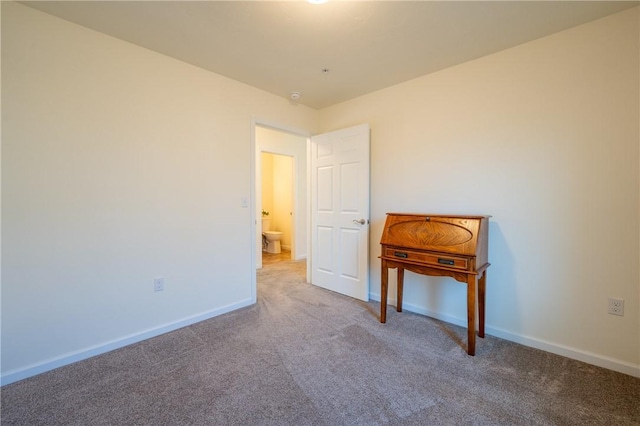 unfurnished bedroom featuring baseboards and carpet