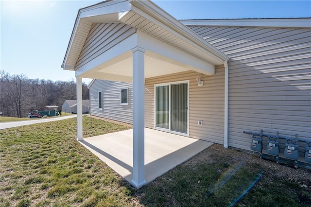 rear view of house featuring a yard and a patio