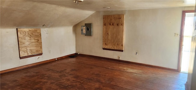 bonus room with hardwood / wood-style flooring, electric panel, baseboards, and lofted ceiling