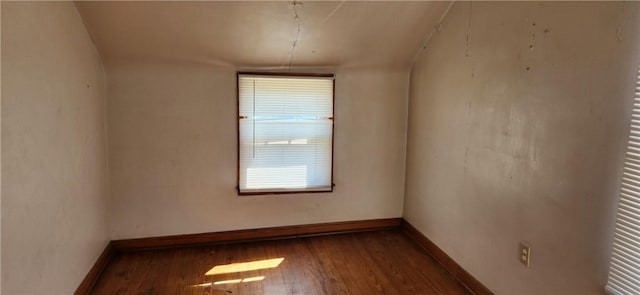 empty room with wood finished floors and baseboards