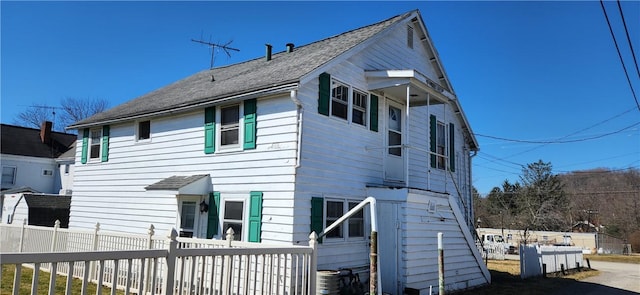 rear view of house with a fenced front yard