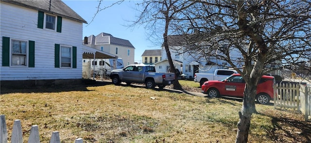 view of yard with a carport and fence