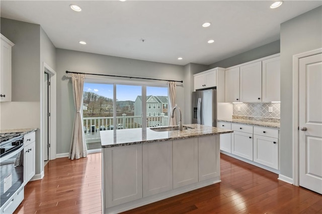 kitchen featuring white cabinets, appliances with stainless steel finishes, and a sink