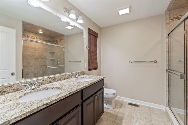 bathroom with a sink, baseboards, toilet, and a shower stall